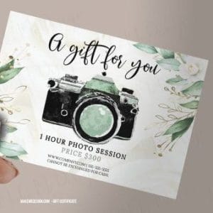 Hand holding a floral-themed photography gift card featuring a vintage camera and details for a 1-hour photo session